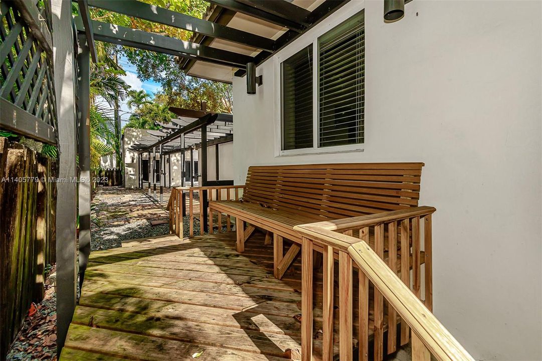 Located behind the house is this raised deck with a bench that provides a quiet place to enjoy.