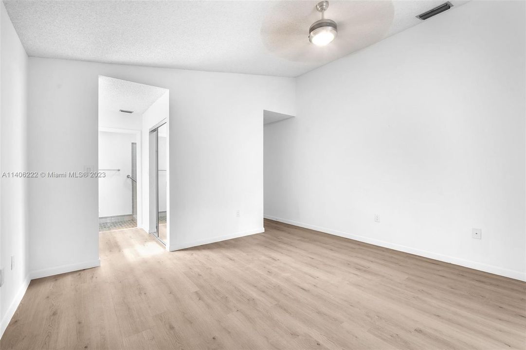 Spacious master bedroom with brand new ceiling fan with light