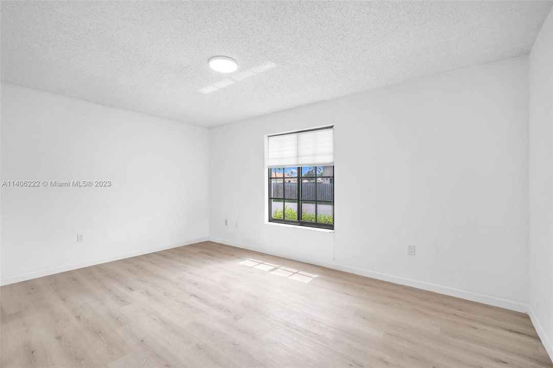Bedroom no 2 with new laminate flooring and recessed lighting.