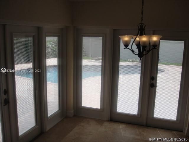 HURRICANE IMPACT DOORS LEADING TO POOL AREA OFF KITCHEN DINING AREA