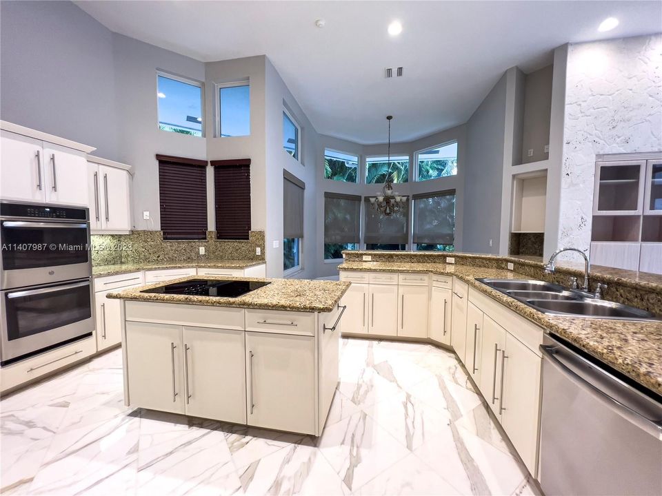 expansive kitchen with double wall ovens