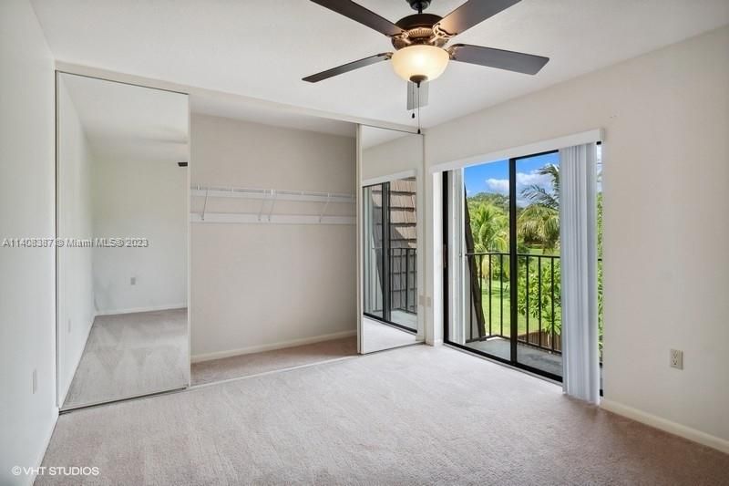 Guest bedroom with large mirrored closet