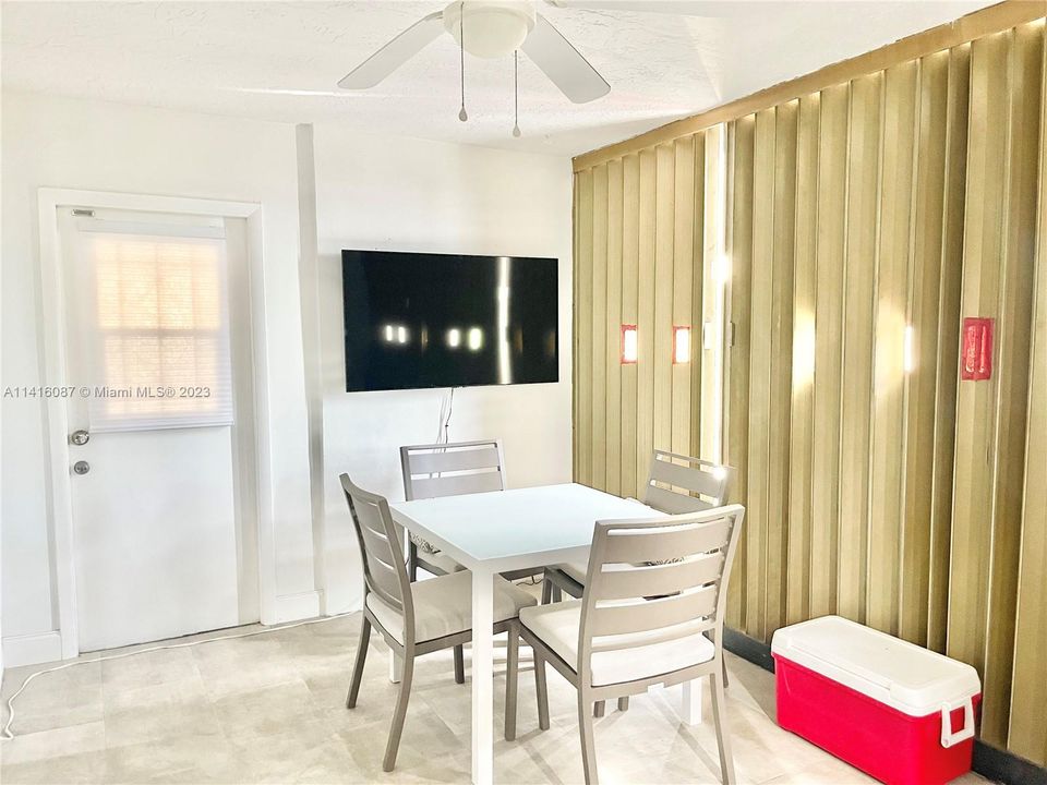 Patio with view of exit door and hurricane shutters