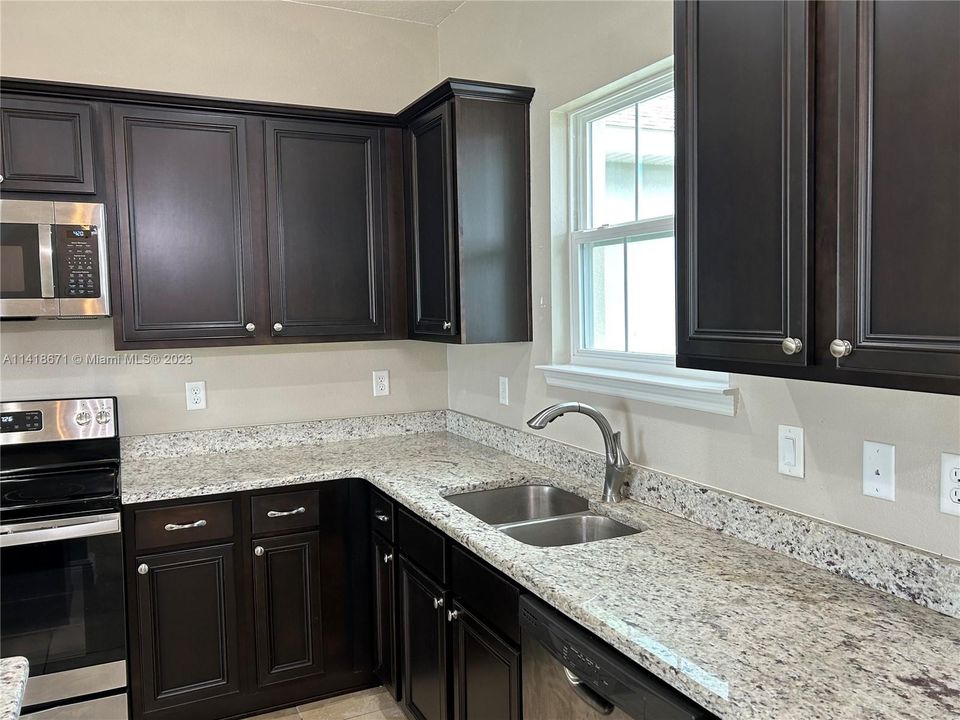 Kitchen has SS appliances and granite countertop