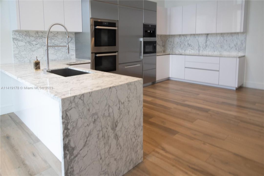 common area kitchen adjacent to common area dining room