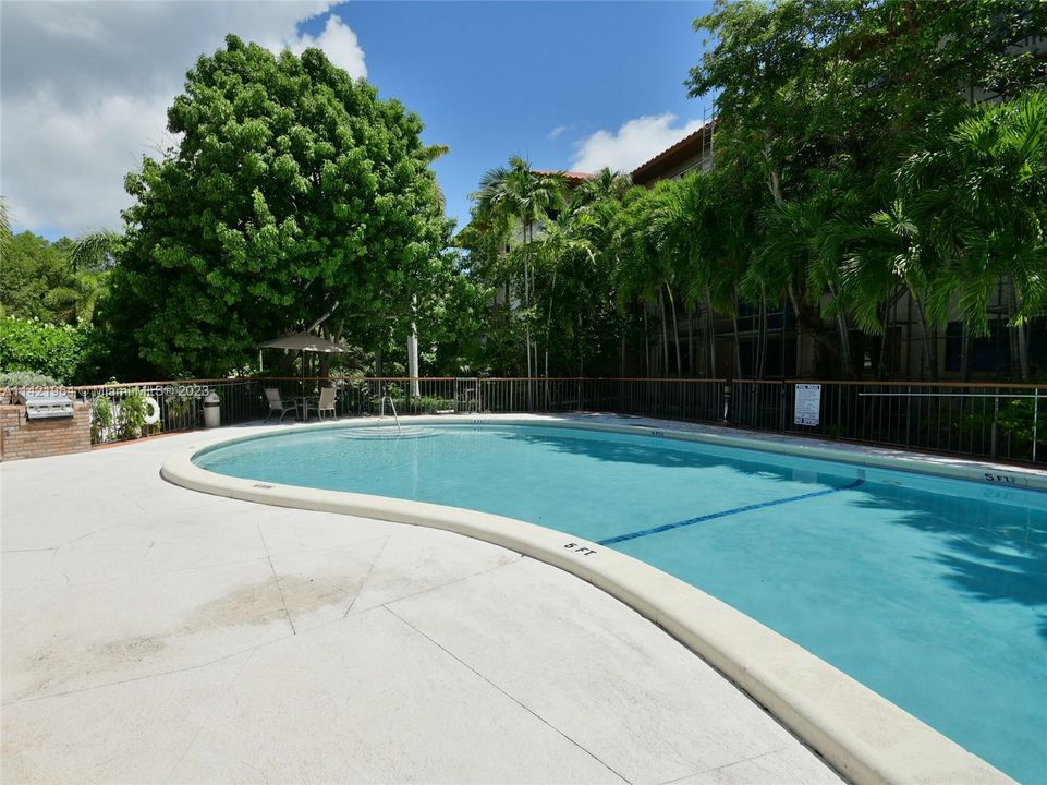 small pool with BBQ area