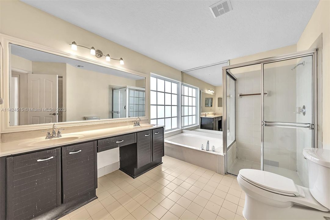 Primary bathroom with double vanities, separate shower and tub.