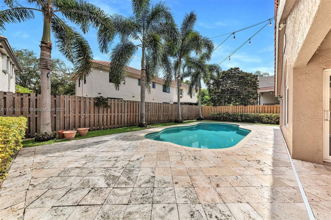 Spacious travertine pool deck.