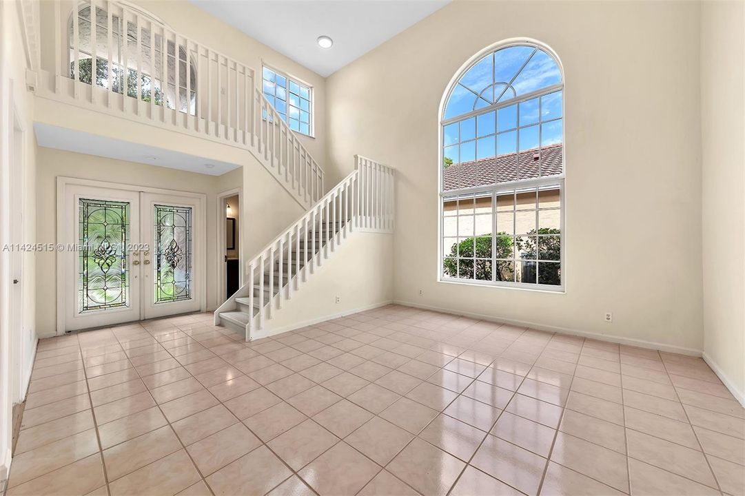View to soaring two story living room.