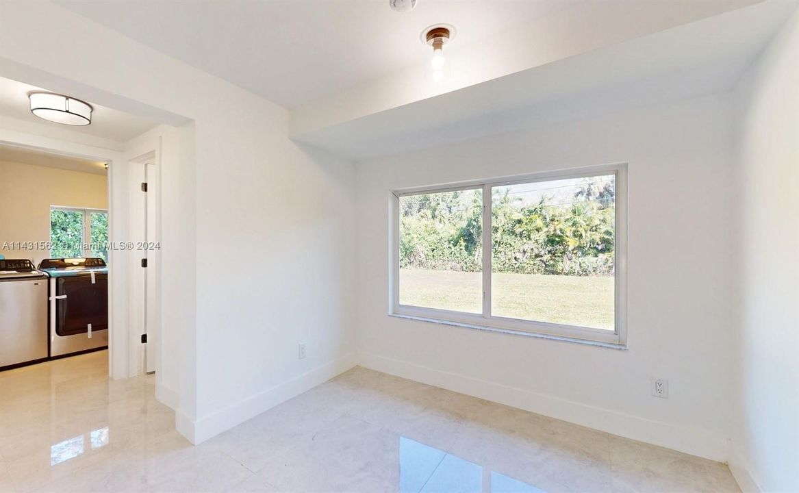 Here is the space for the Breakfast area to have your first cup of coffee! Nice view of the large backyard! To the left you will see the entrance to the 1/2 Bath and the Laundry room with its new Samsung Washer/Dryer & new Water-heater.