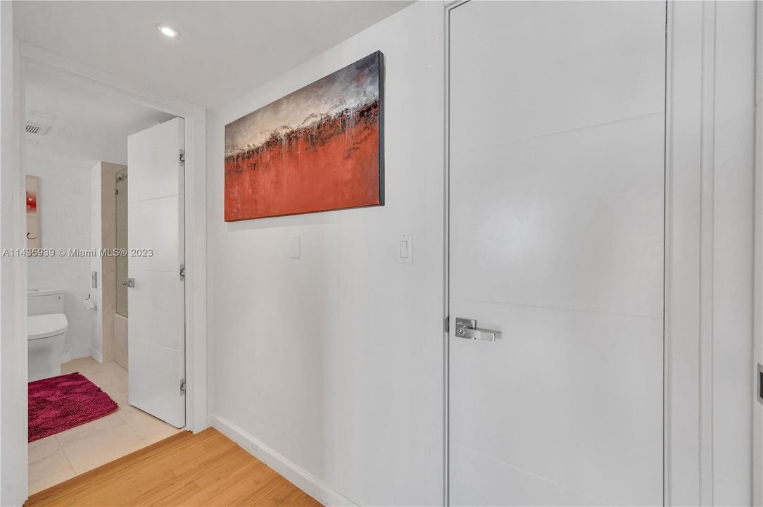 Closets/hallway into primary bathroom