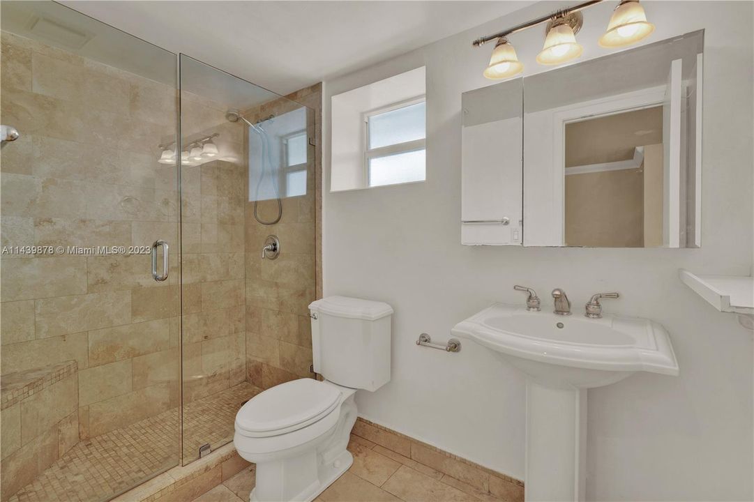 Remodeled frameless glass shower with makeup mirror