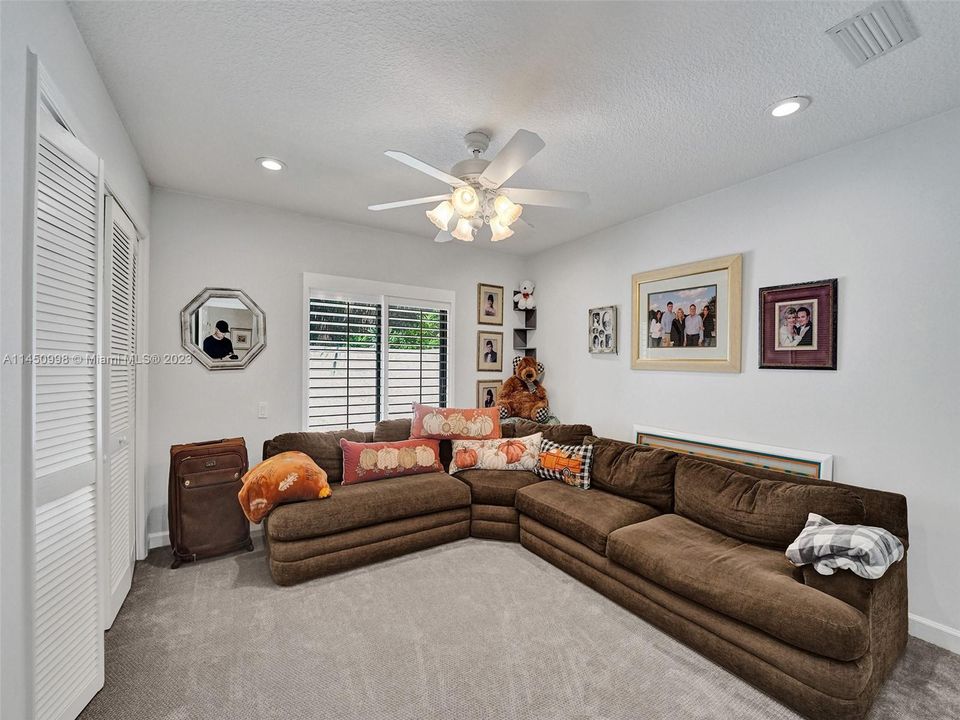 Front bedroom with lots of beautiful landscaping outside the front window.