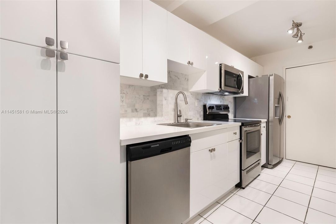 Fully renovated kitchen with new stainless steel appliances.