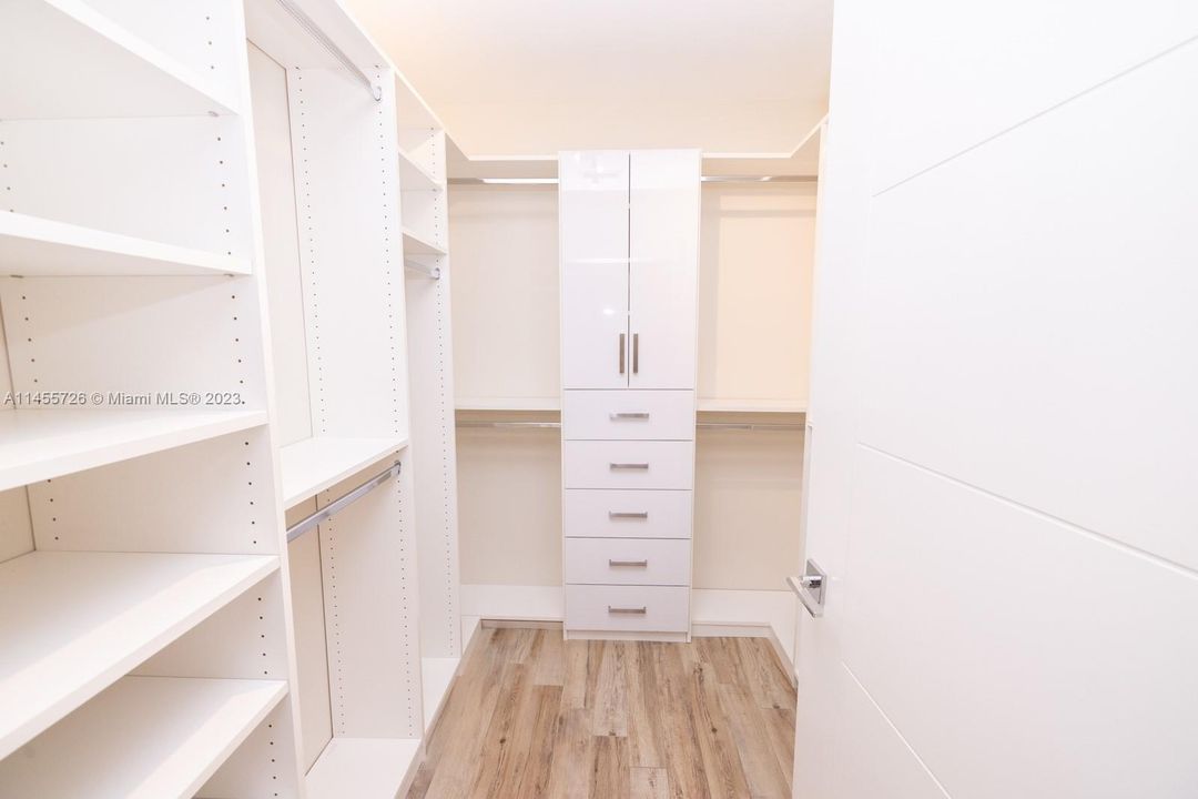 Master walk-in custom shelving and drawers.