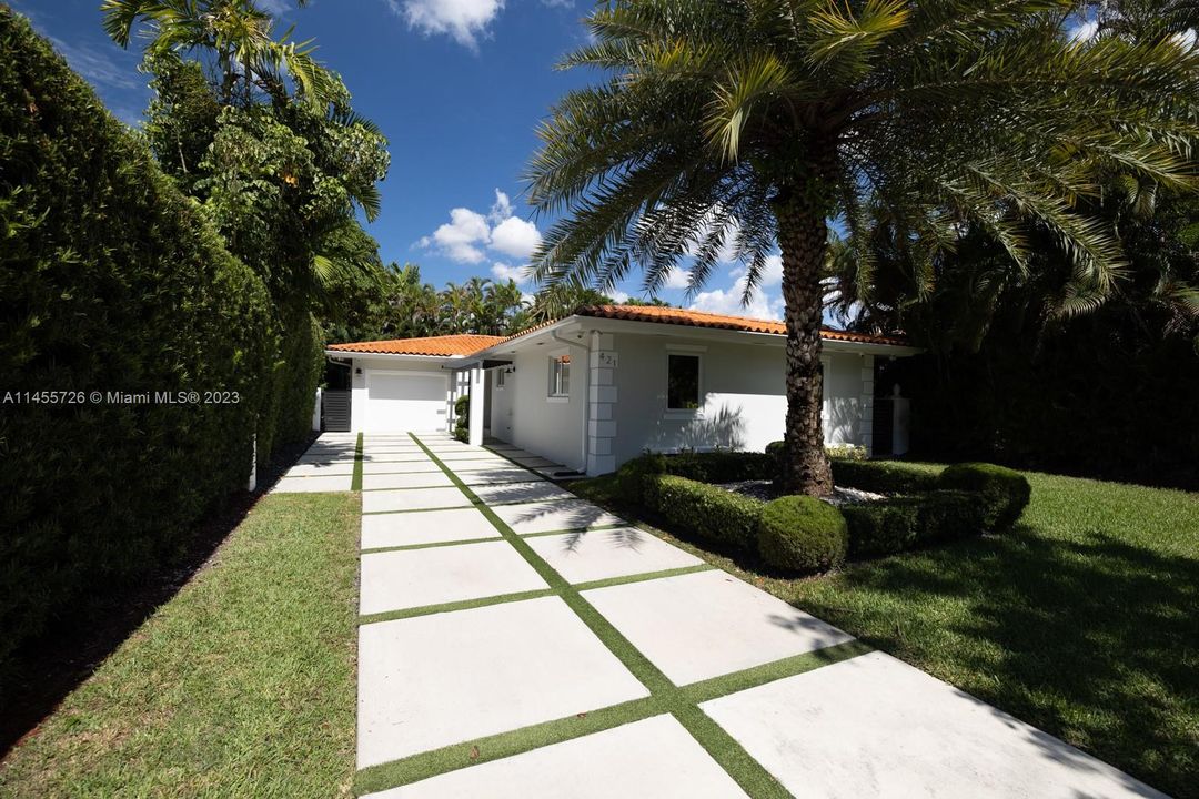 Privacy hedge and custom driveway.