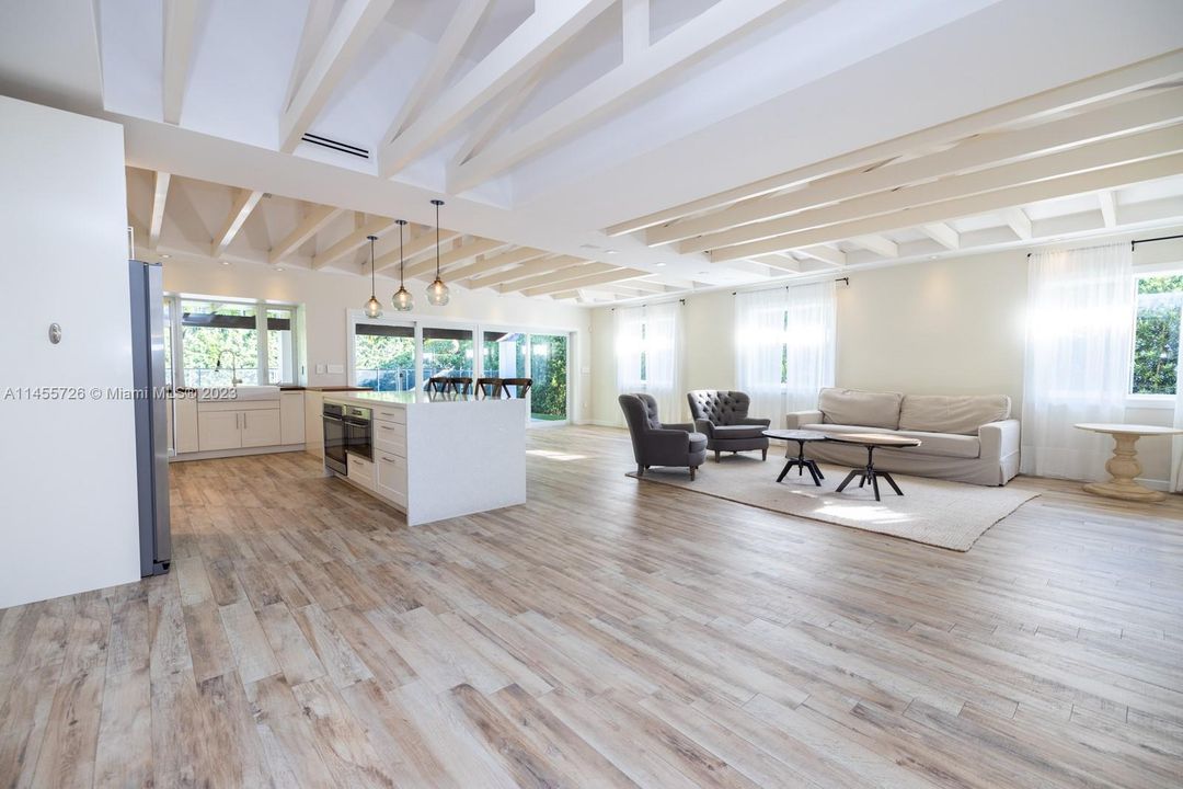 Open kitchen, living room and dining room which views the patio, pool and backyard that has no care artificial turf!