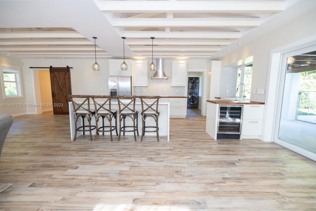 Counter bar sitting for casual dining and your own wine cooler.