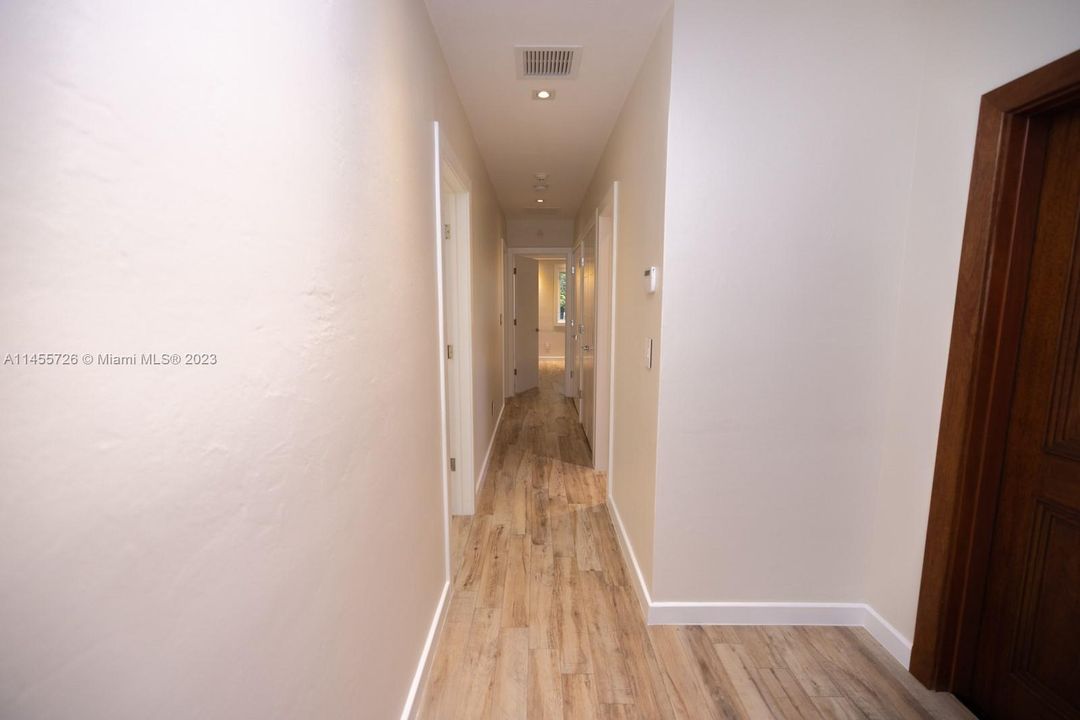 Hallway to 2nd bath, master ensuite and two additional bedrooms.