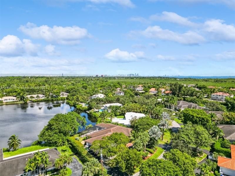 This view is looking North, North East and one can see the tall buildings of Coconut Grove and Downtown Miami/Brickell Ave.as well as. 451 Rovino Ave, Coral Gables, FL 33156 is in this picture located a little bit right of the center of this picture with Primary Bedrom jutting out towards the Lake!
