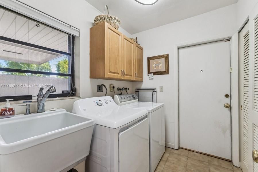Laundry room has a real Laundry tub and the door leads into the 2 Car-Garage