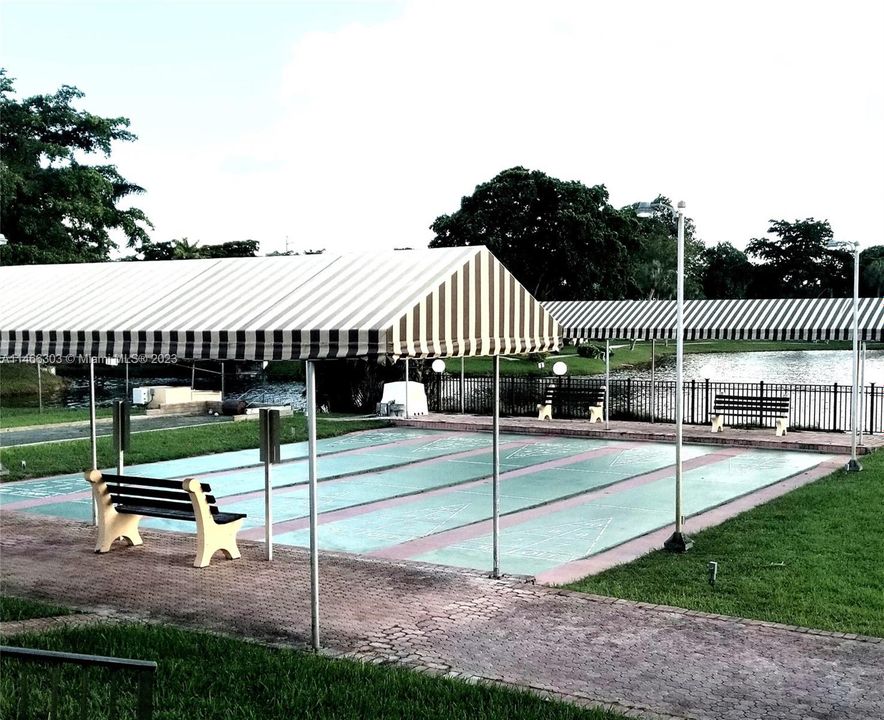 SHUFFLE BOARD AREA BY OUTSIDE CLUBHOUSE POOL.