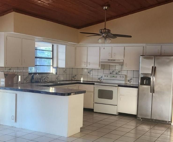 Kitchen with vaulted wood ceiling