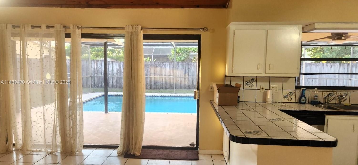 Kitchen, Family Room Overlooking Fenced In Pool