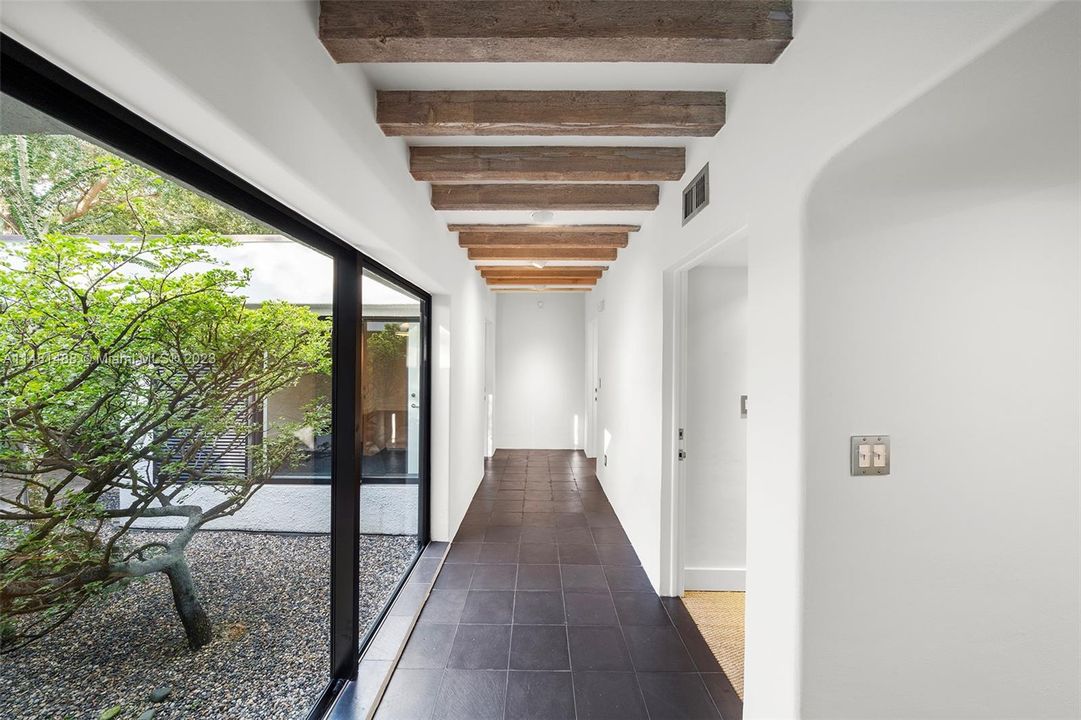 Hallways to bedrooms open to atrium courtyard.