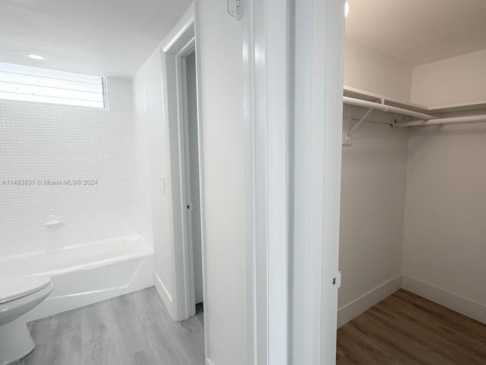 Walking closet in main bedroom through bathroom