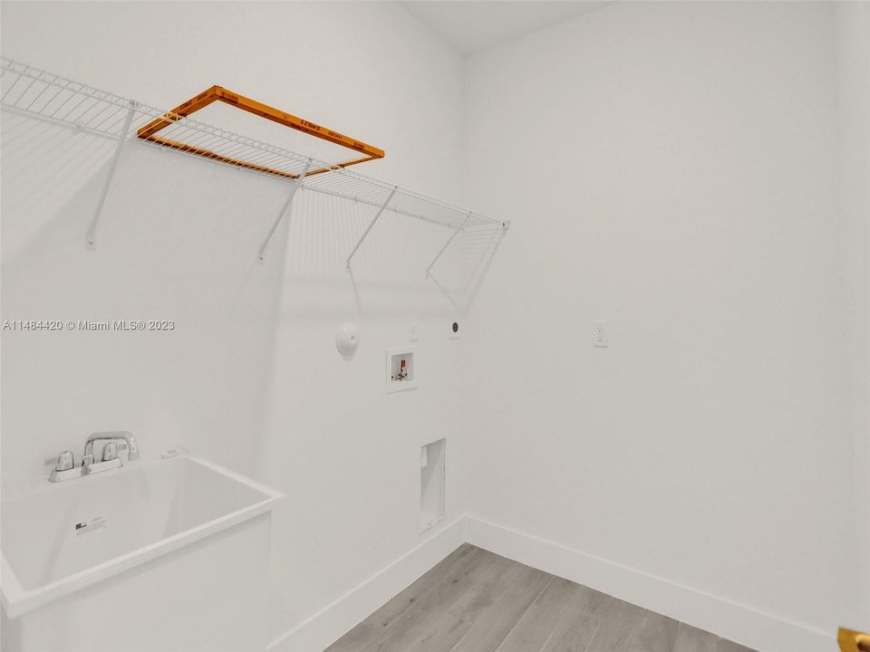 Oversized laundry room with sink