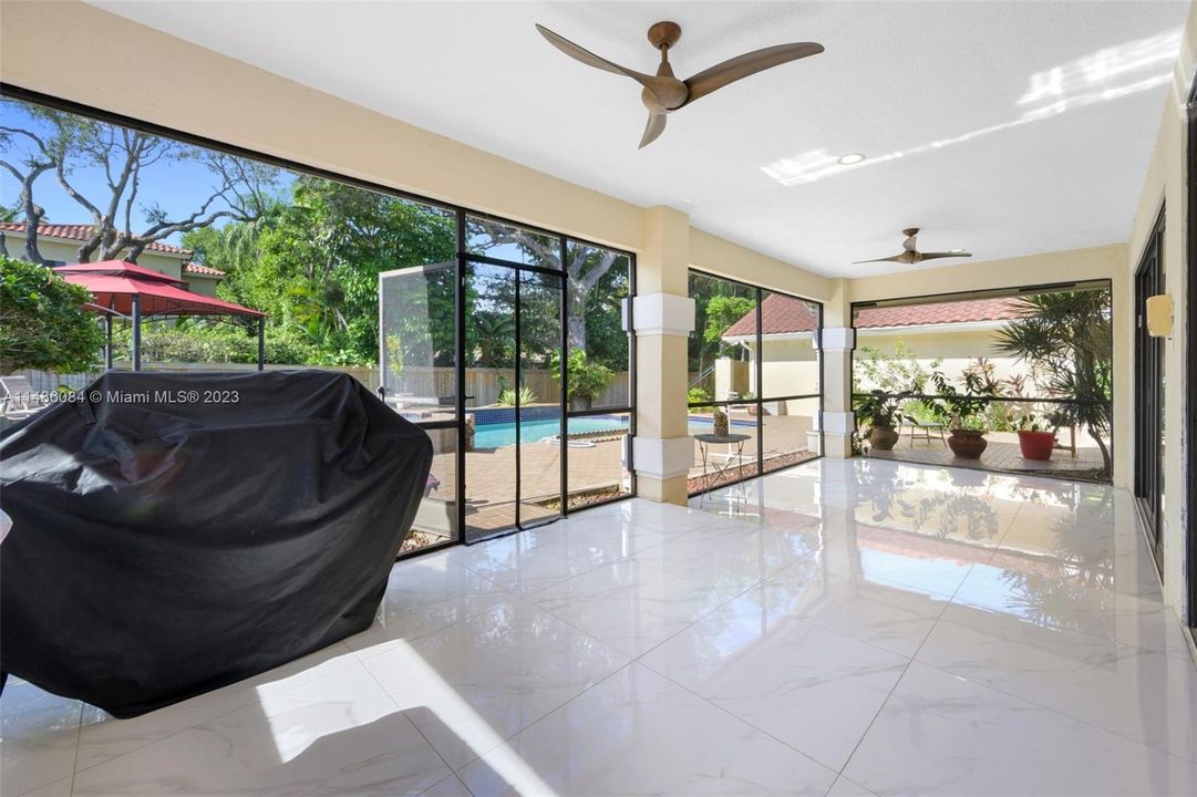 Sun Room located off the kitchen leads to the oversized pool and lot                                        Fence was replaced in 2022 with permits