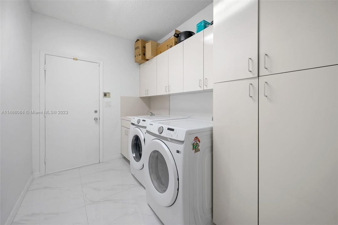 Laundry Room is located off the kitchen and bedroom.  Door is to two car oversized garage