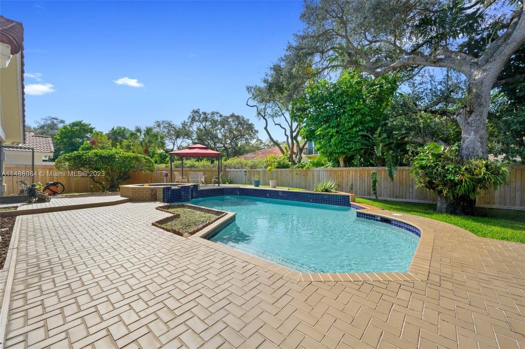 Gorgeous oversized pool with built in hot tub sits on a 14,000 SF lot-Bonus Sunroom-+oversized 2 car garage, renovated high end kitchen, fabulous floor plan, over 4000 SF interior space.