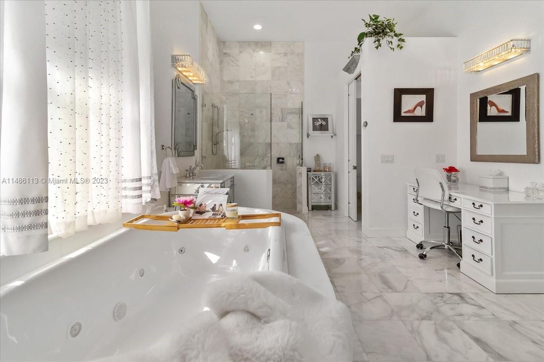 Marble tile, gorgeous jetted tub and his and her water closets!