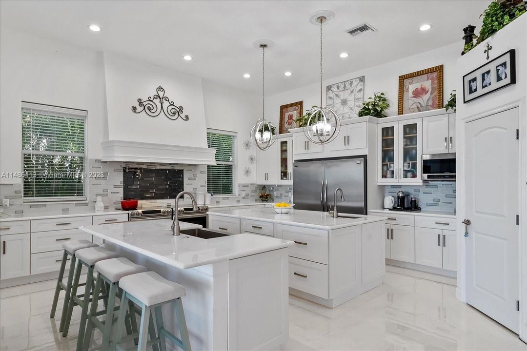 WOW!  That describes this kitchen. 2 of everything and stunning imported marble countertops!