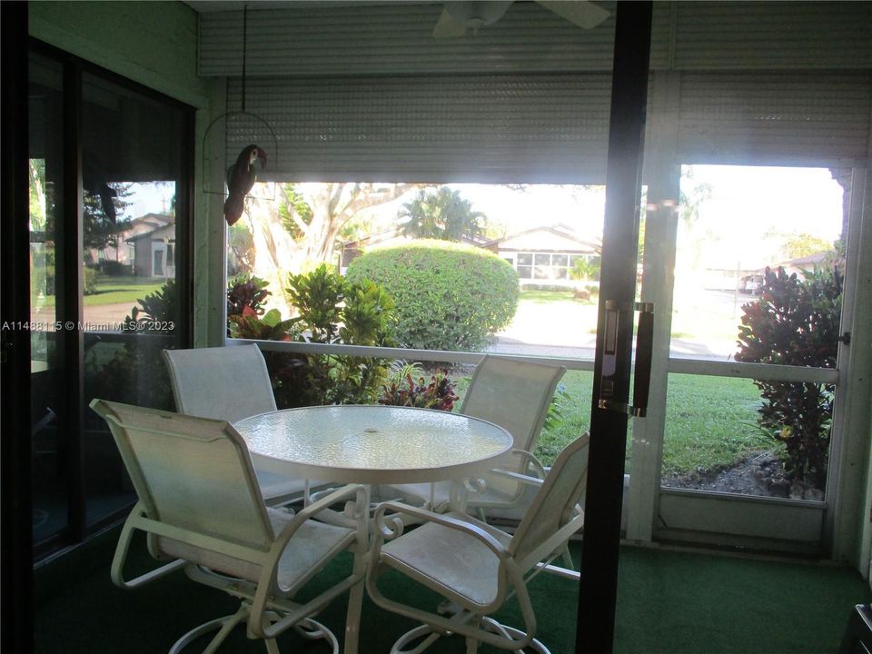 PATIO WITH SHUTTER UP AND STORAGE ROOM TO RIGHT