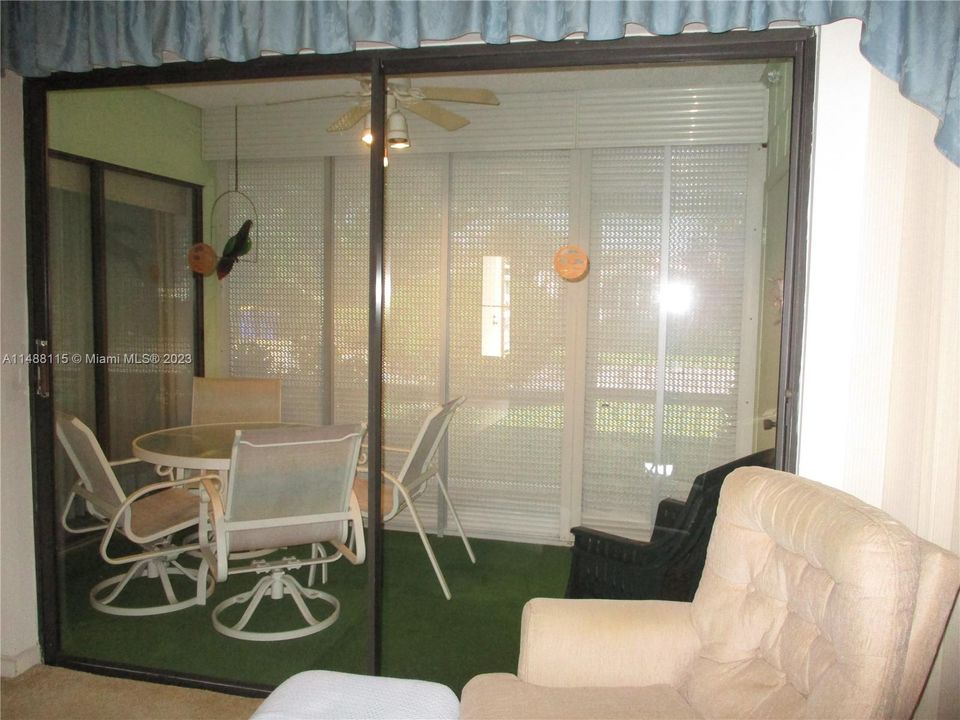 PATIO WITH PULL DOWN SHUTTERS & SCREENED DOOR