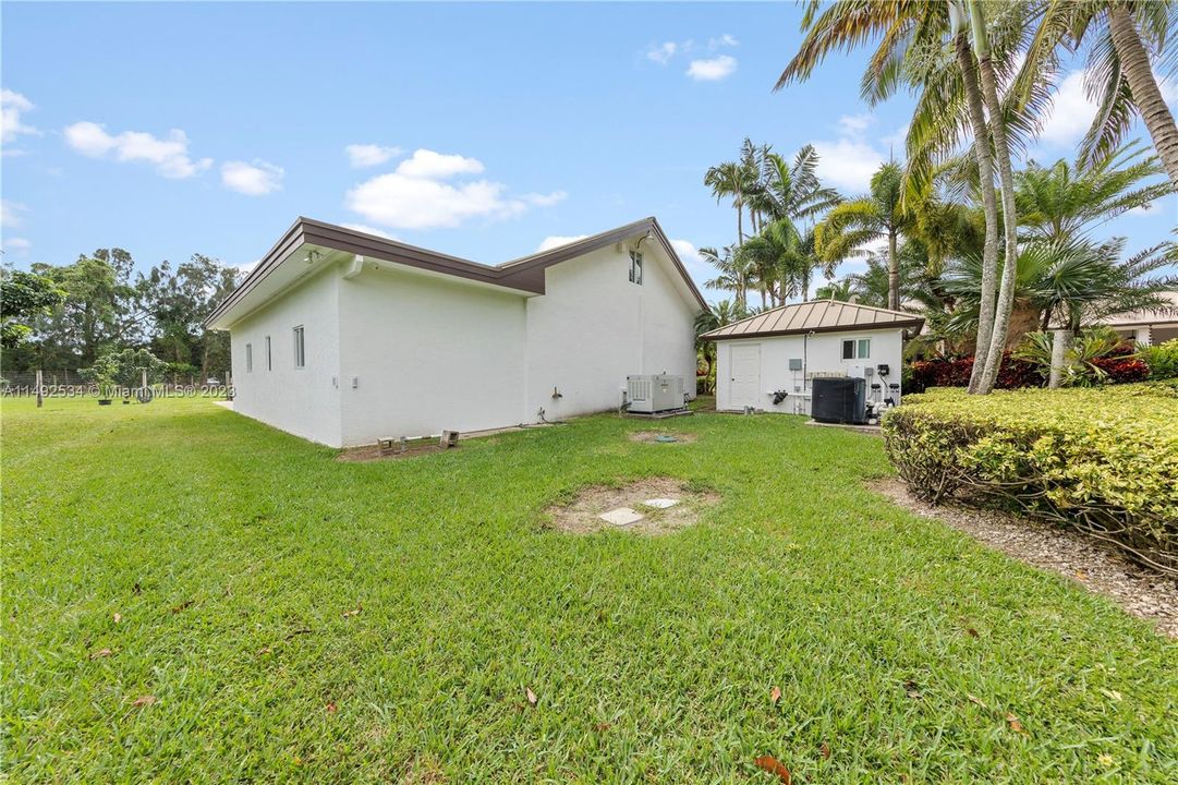 SEEN IS REAR OF GARAGE AND THE WATER TREATMENT BLDG.THE GENERATOR SHOWN IS A 48KW W/ 1000 LBS BURIED PROPANE TANK THAT RUNS THE GENERATOR, HEATS THE POOL/SPA AS WELL AS THE FIREPLACE, CLOTHES DRYER, COOKTOP, OVEN & OUTSIDE BAR-B-Q