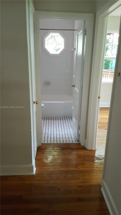 Entry to family bath hared by large and small bedrooms