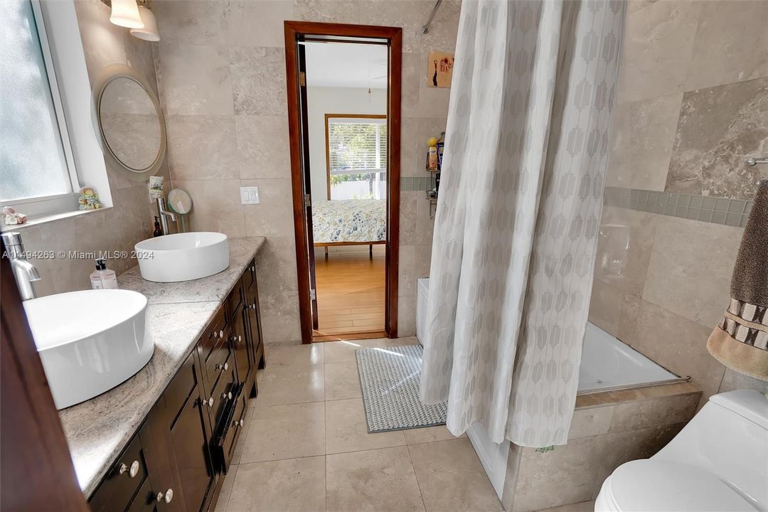 Jack and Jill bathroom connecting two bedrooms - West view