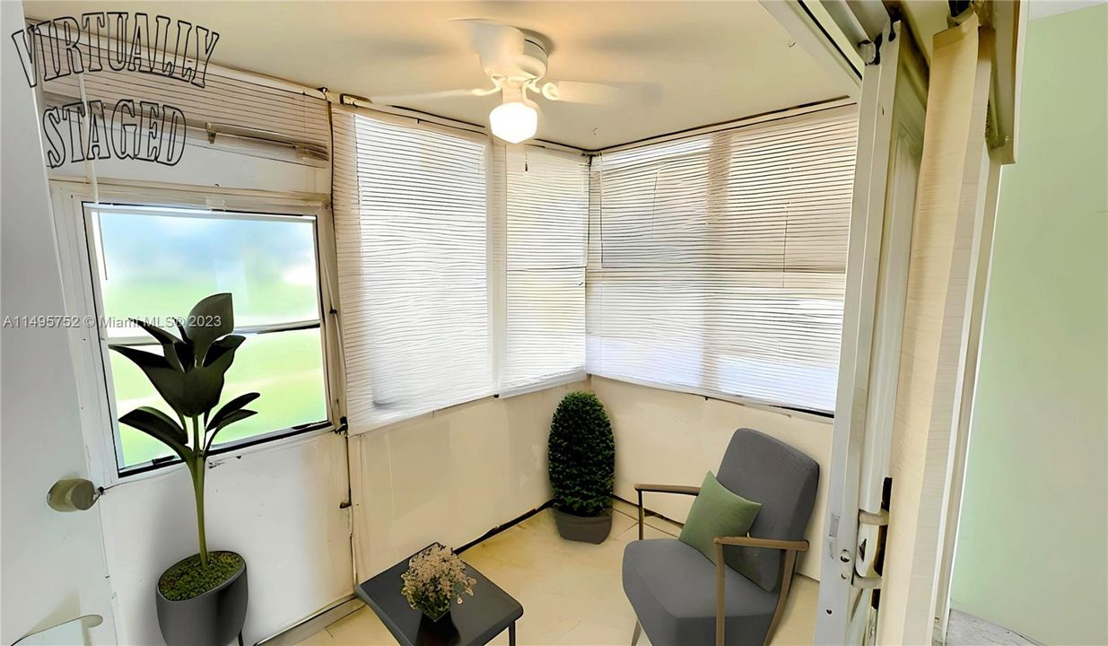 Enclosed Porch - Staged Picture. In an effort to maintain transparency, we disclose that the contents within this image have been added digitally, and elements in this photograph including furnishings and decorations have been virtually staged, to provide a visual example of the property’s possibilities and potential design ideas; therefore, we encourage verifying on-site characteristics/conditions before making any decisions.