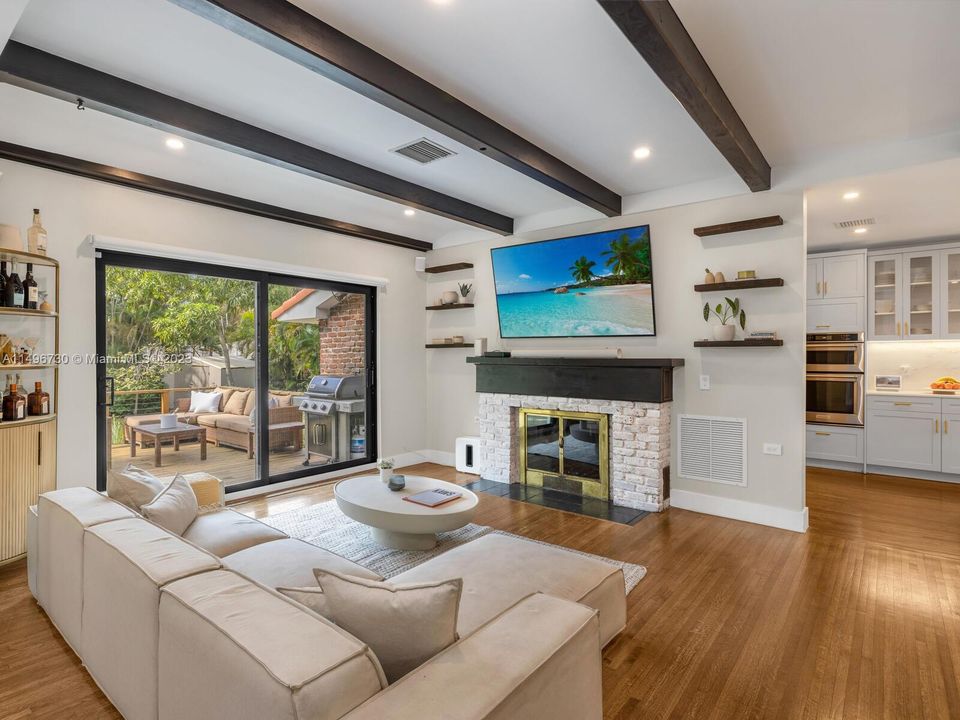 Open Living Room with Fireplace and Sliding Doors to the Back Deck