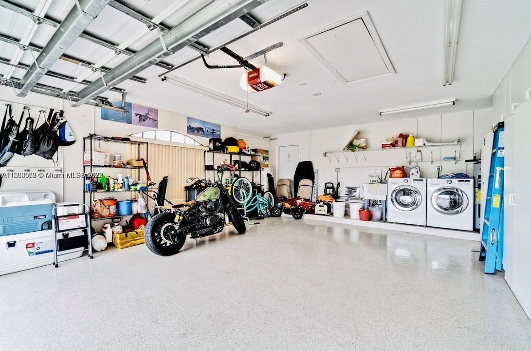 Garage with storage cabinets and laundry area