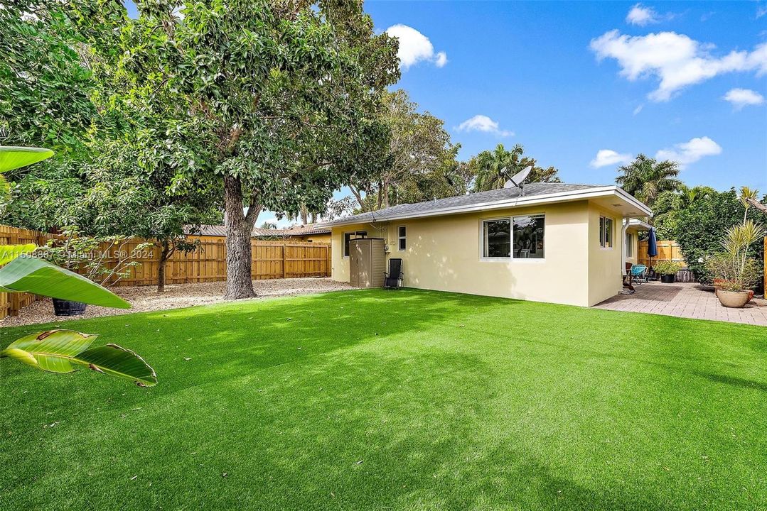 Low maintenance yard with turf and stone. Avocado tree. Private fully fenced in yard.