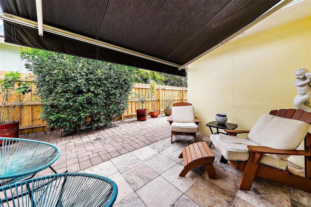 Covered patio with retractable awning. Stone pavers, private fully fenced in yard.