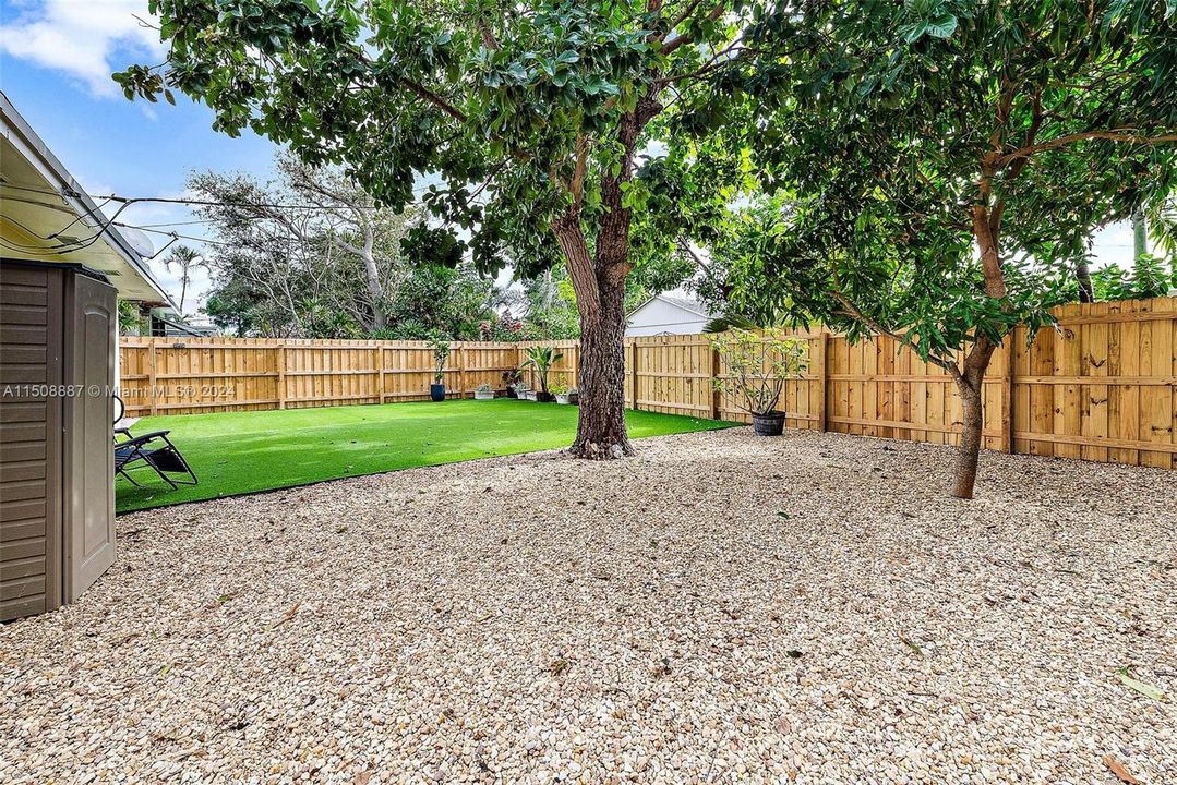 Low maintenance yard with turf and stone. Avocado tree.  Private fully fenced in yard. Fence installed August 2023.