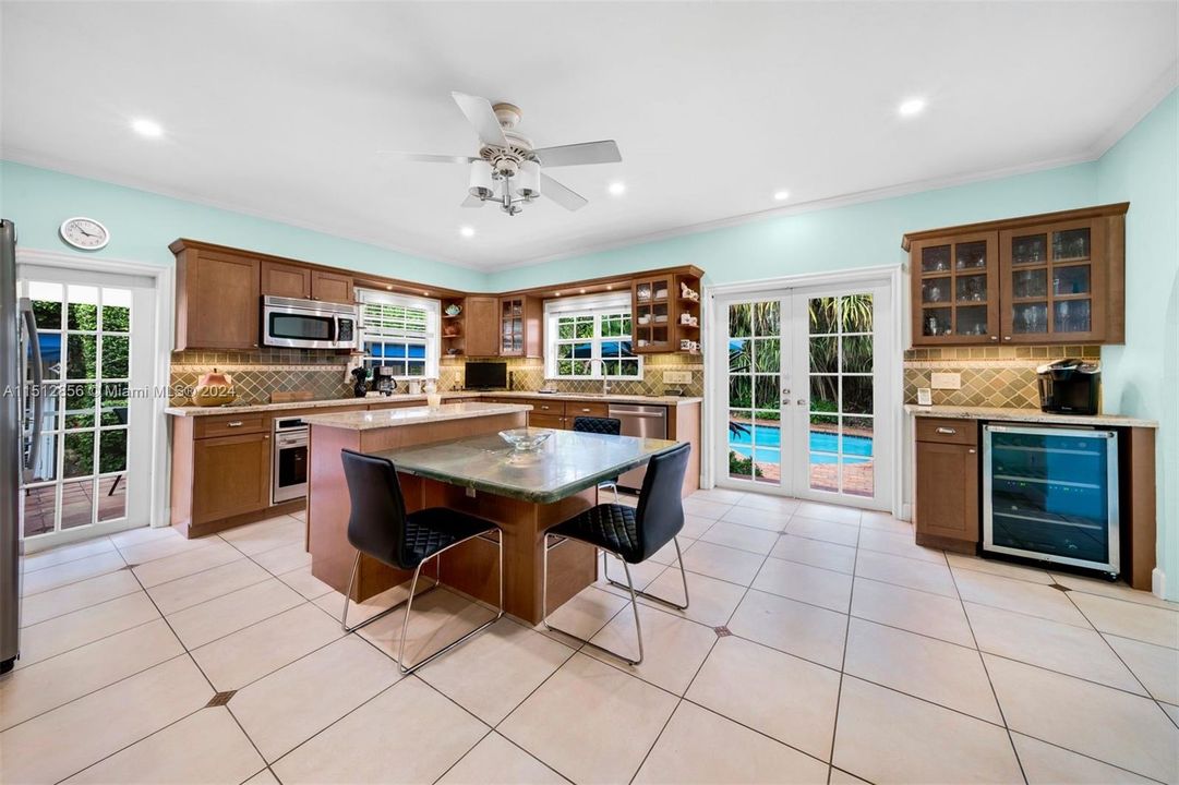 Kitchen Offers Direct Acccess to Rear Screened Porch & Pool