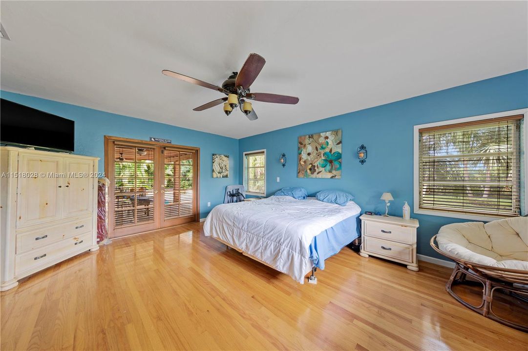 MASTER BEDROOM OPENS TO POOL AREA THROUGH FRENCH DOORS