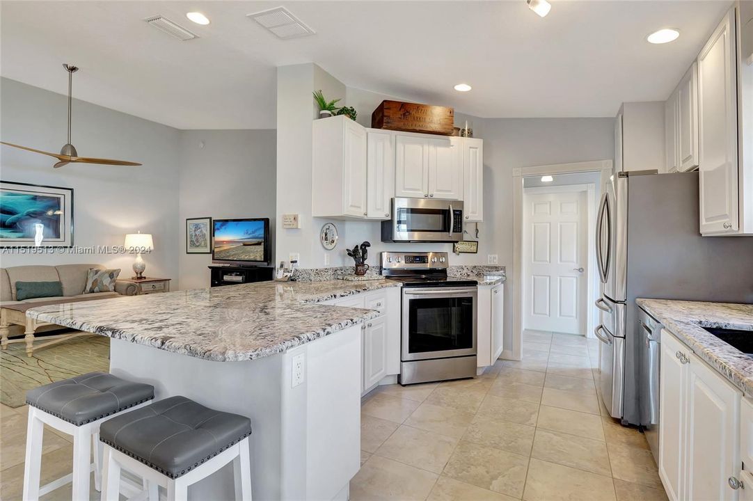 Beautifully upgraded & open kitchen with granite countertops & SS appliances